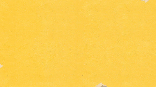 a piece of yellow paper with torn edges